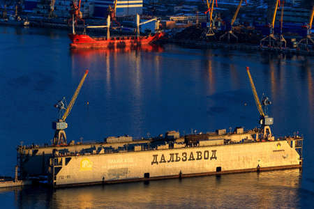 Vladivostok, Russia, 2017 - Dalzavod dry dock stands in the Golden Horn Bay against the backdrop of...