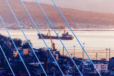 Vladivostok, Russia, 2017 - The ship stands on the roadstead during sunset in the Golden Horn Bayのeditorial素材
