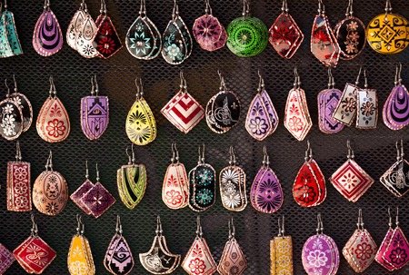 Many colorful handmade earrings for sale at outside street market fairの写真素材