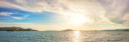Beautiful Sunset on the sea, in the background mountains. Summer eveningの写真素材
