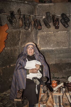Living Bethlehem Christmas 2012, Navamorcuende, Toledo, SpainCobbler, craftsman, shoes, work shoemaker, sandals, albarcaのeditorial素材