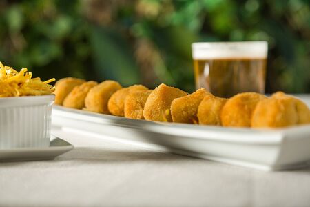 homemade croquettes on a plate with a beerの写真素材