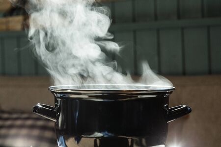 Black pot profile view steamingの写真素材