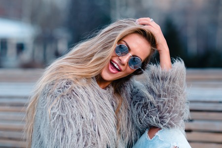 Close up shot stylish happy young woman in coatの写真素材