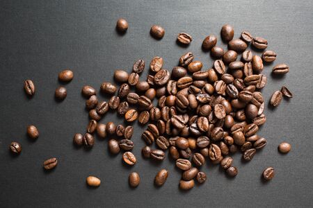 Roasted coffee beans brown seeds texture background wallpaper. Top view.の写真素材