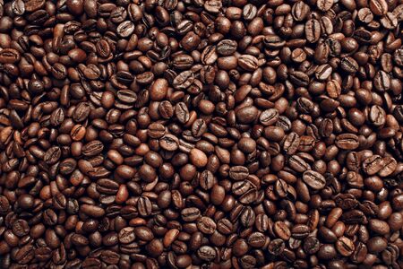 Roasted coffee beans brown seeds texture background wallpaper. Top view.の写真素材