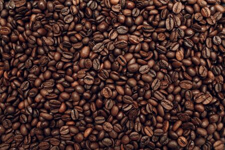 Roasted coffee beans brown seeds texture background wallpaper.の写真素材