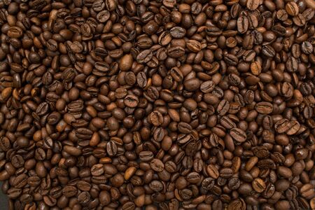 Roasted coffee beans brown seeds texture background wallpaper. Top view.の写真素材