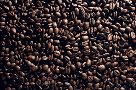 Roasted coffee beans brown seeds texture background wallpaper.の写真素材