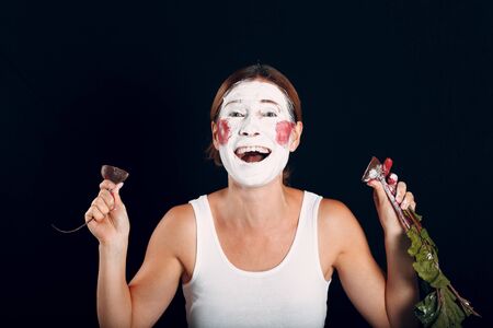 Young woman applying make-up, paints face with beet and makeup. How not to do make up concept.の写真素材