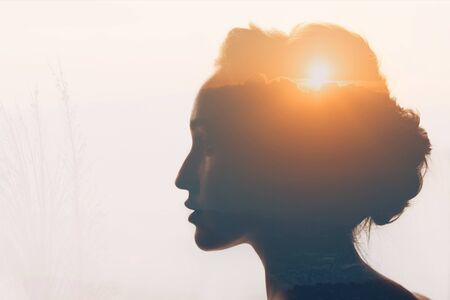 Woman with sun and clouds in her headの写真素材