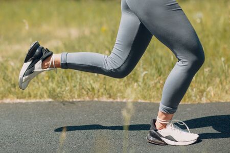 Runner woman in running shoes closeup of woman sporty legs. Female jogging.の写真素材