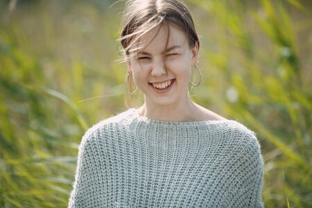 Pretty smiling young woman portrait outdoor in the park at summer.