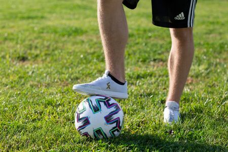 Soccer player is standing with a ball under his foot. Football conceptの写真素材