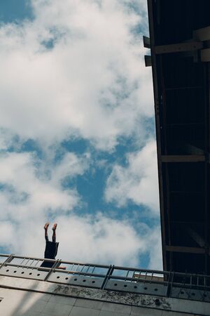 Young sporty guy doing parkour at the city street.の写真素材