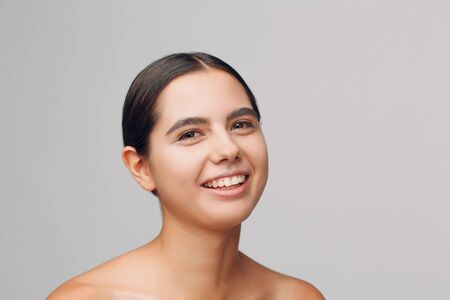 Portrait of young beautiful positive woman with nude make up.の写真素材