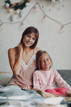 Mother and little daughter child girl at home.の写真素材