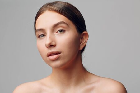 Portrait of young beautiful positive woman with nude make up.の写真素材