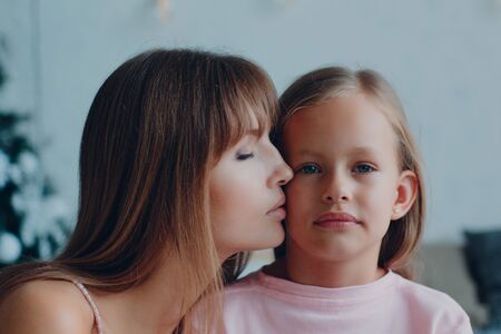 Mother and little daughter child girl at home.の写真素材