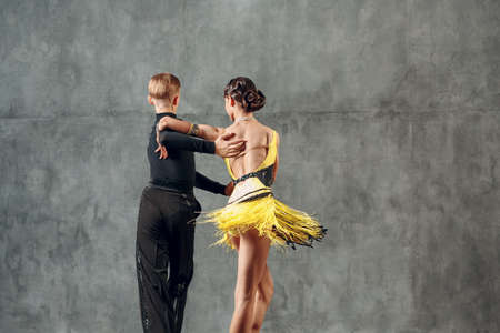 Young couple dancers dancing ballroom dance cha cha cha.の写真素材