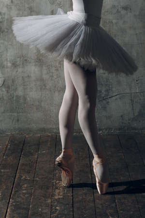 Ballerina female. Young beautiful woman ballet dancer, dressed in professional outfit, pointe shoes and white tutuの写真素材