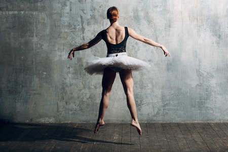 Ballerina female. Young beautiful woman ballet dancer, dressed in professional outfit, pointe shoes and white tutuの写真素材