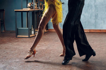 Ballroom dance samba. Close up of dancing legs of dancers.