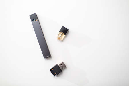 MOSCOW - 26 June 2020: Juul e-cigarette nicotine vapor stick and pods.のeditorial素材