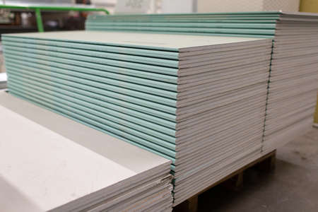 Pallet with Drywall sheets plasterboard in the building warehouse storeの写真素材