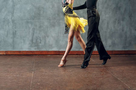 Ballroom dance samba. Young couple in yellow and black clothes dancing.の写真素材