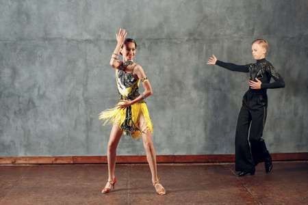 Young couple dancers dancing ballroom dance cha-cha-cha.の写真素材