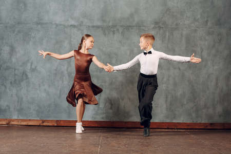 Young dancers boy and girl dancing in ballroom dance Sambaの写真素材