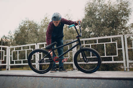 Professional young sportsman cyclist with bmx bike at skatepark.の写真素材