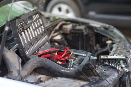 Car with open hood, set of keys and wires for ignition on engine.の写真素材