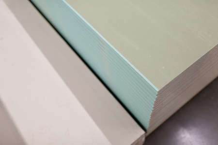 Pallet with Drywall sheets plasterboard in the building warehouse store.の写真素材