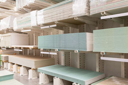Pallet with Drywall sheets plasterboard in the building warehouse store.の写真素材