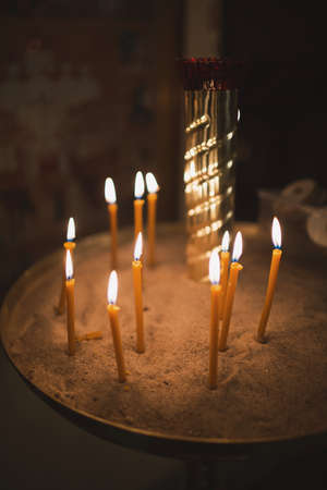 Orthodox Christian utensils in the church. Burning candles.の写真素材