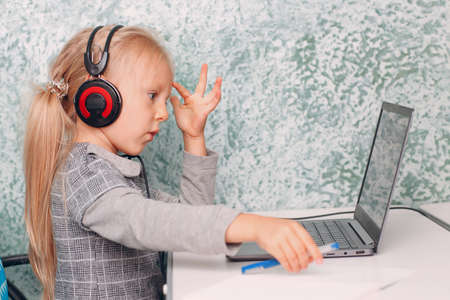 Young student little girl with laptop learning and preparing back to schoolの写真素材