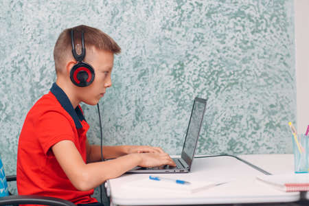 Young student boy with laptop learning and preparing back to school