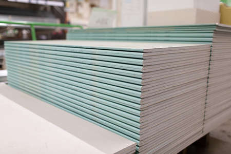 Pallet with Drywall sheets plasterboard in the building warehouse store.の写真素材