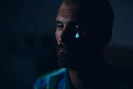 Crying sad man portrait with tears in eye.の写真素材