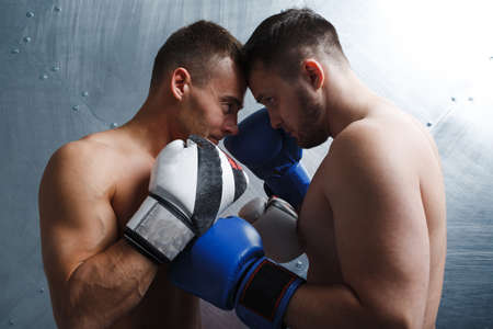 Two men boxers fighting muay thai boxing. Face to face posing.の写真素材