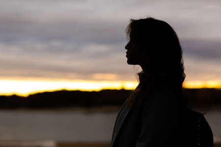 Portrait profile of attractive young woman outsideの写真素材