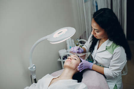 Woman Getting Vacuum Cleaning Face Treatment At Beauty Clinic or Spaの写真素材