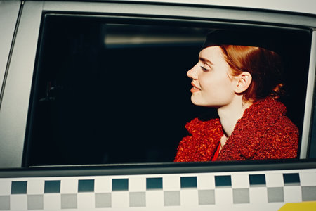 Young woman riding in taxi car on back seatの写真素材