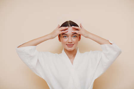 Young woman doing face building facial gymnastics self massage and rejuvenating exercisesの写真素材