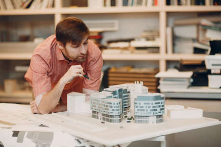 Architect with blueprints and layout design project at officeの写真素材