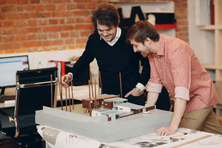 Architect with blueprints and layout design project at officeの写真素材