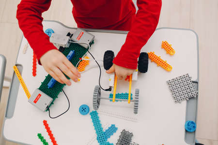 Little boy kid child constructor checking technical toy. Children Robotics constructor assemble robot.の写真素材
