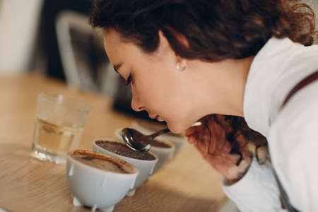 Cup Taster Girl Tasting Degustation Coffee Quality Test. Coffee Cuppingの写真素材